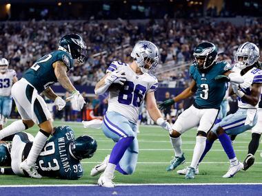 Dallas Cowboys tight end Dalton Schultz (86) slides into the end zone after running in a...