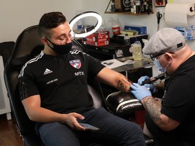 FC Dallas Social Media Coordinator, Eddie Koton, receives a tattoo from Mando Aguilar at La Gallery TCTX in The Colony, TX, on Aug. 5, 2021.