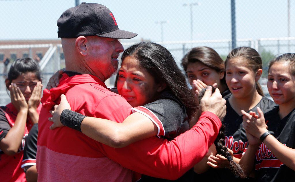 Hillcrest infielder Abigail Cardena shares an emotional hug with assistant coach Brian Smith...