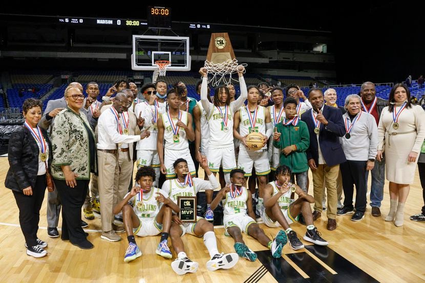 The Madison basketball team poses for photos after winning the Class 3A state championship...