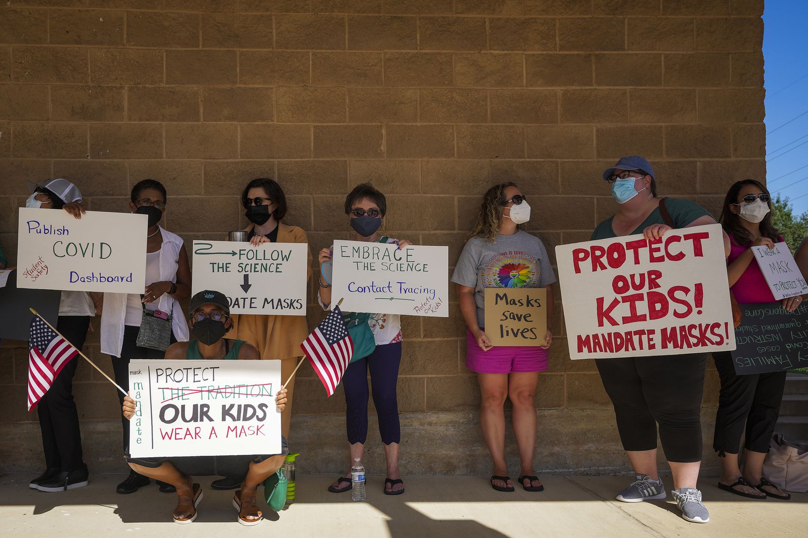 Supporters of mask mandates line up waiting to enter the Carroll ISD school board meeting on...