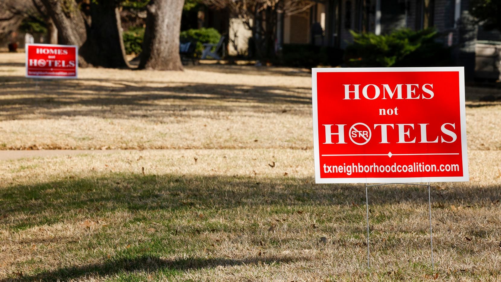 Signs advocating against short-term rentals have been placed in the lawns of homes along...