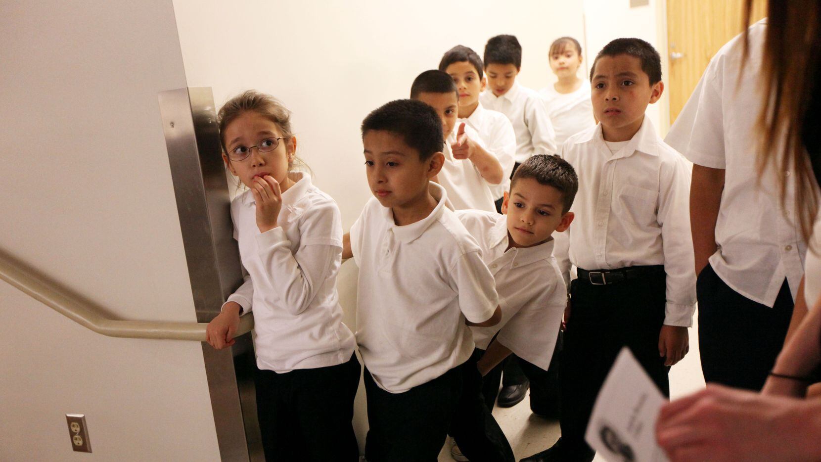 Students at the predominantly-Hispanic Adelfa Callejo Elementary School in Dallas wait to...