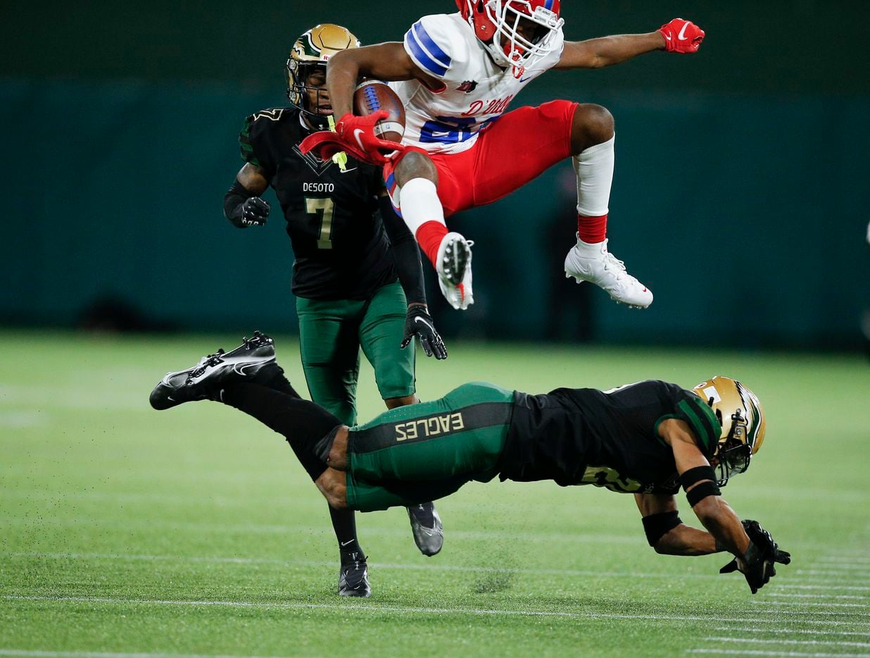 Duncanville sophomore wide receiver Lontrell Turner (22) leaps over DeSoto sophomore safety Jaden Milliner-Jones (21) during the first half of a Class 6A Division I Region II final high school football game, Saturday, January 2, 2021.  Duncanville won 56-28. (Brandon Wade/Special Contributor)