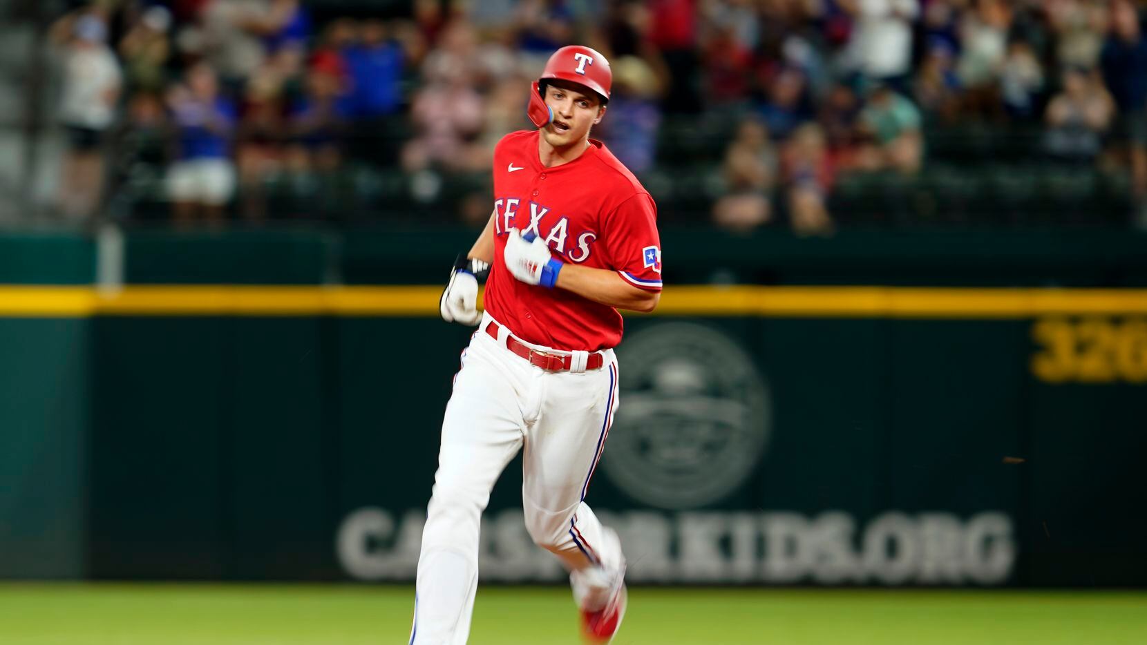 Texas Rangers' Corey Seager runs the bases after hitting a solo home run off Seattle...