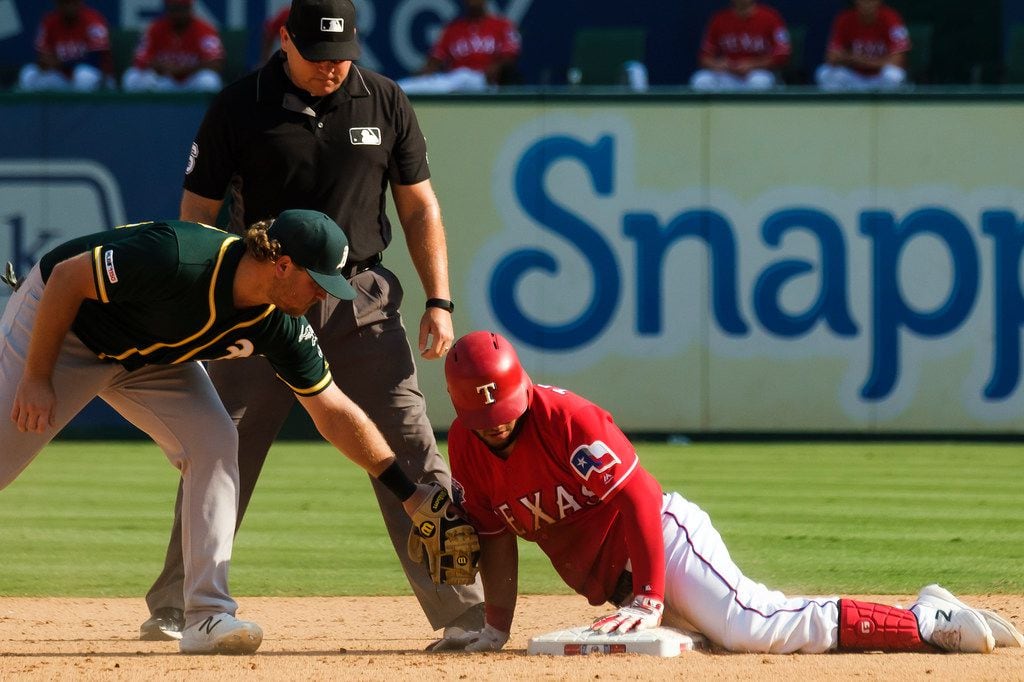 Texas Rangers catcher Jose Trevino is safe at second base with a double ahead of the tag from Oakland Athletics second baseman during the eighth inning Sheldon Neuse at Globe Life Park on Sunday, Sept. 15, 2019, in Arlington. (Smiley N. Pool/The Dallas Morning News)