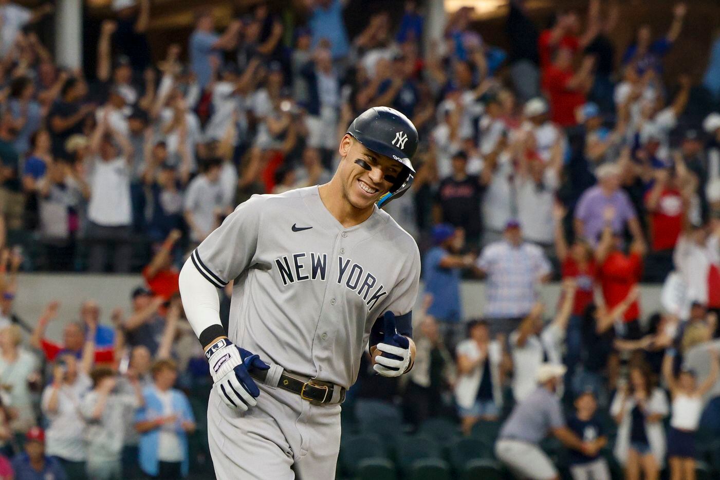 New York Yankees right fielder Aaron Judge (99) smiles as he rounds the bases after hitting...
