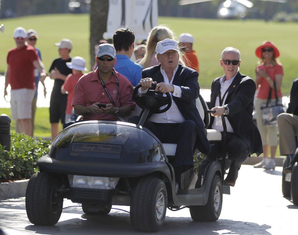 FILE- In this March 6, 2016 file photo, Donald Trump drives himself around the golf course...