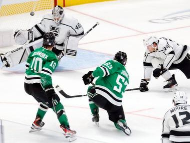 Dallas Stars center Wyatt Johnston (53) takes a shot which is deflected by Los Angeles Kings...