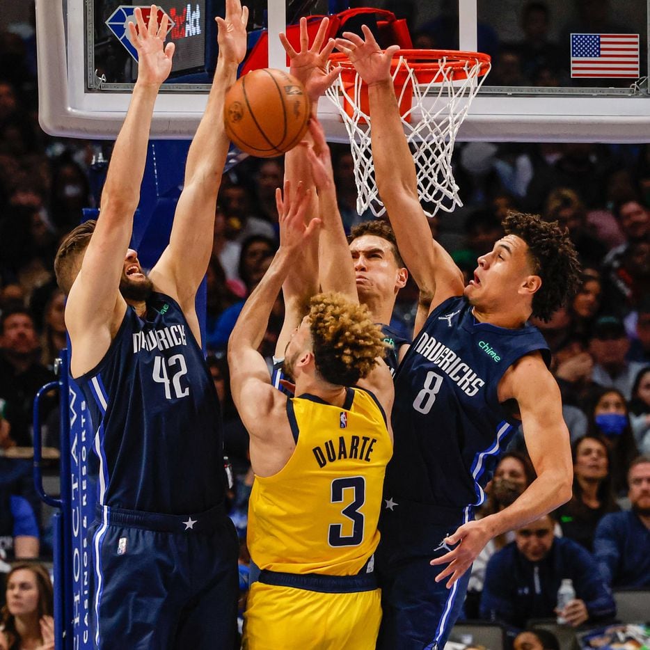 Indiana Pacers guard Chris Duarte (3) goes for a shot as Dallas Mavericks forward Maxi Kleber (42), center Dwight Powell (7) and forward George King (8) block hime during the second half at the American Airlines Center in Dallas on Saturday, January 29, 2022.