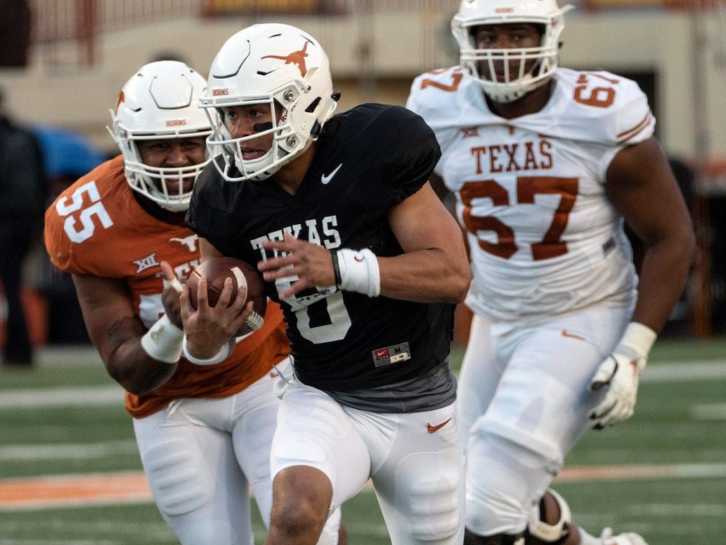University of Texas quarterback Casey Thompson (8) scrambles out of the pocket for a first down as he is chased by Texas defensive lineman D'Andre Christmas-Giles (55) during the Orange and White spring game held at Darrel K Royal Texas Memorial Stadium on Saturday, April, 13, 2019, in Austin, Texas.  (Rodolfo Gonzalez/ Special Contributor)
