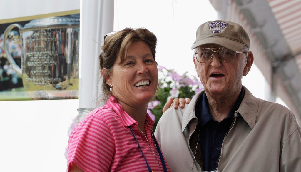Dan Jenkins poses for a photo with his daughter, longtime Washington Post sportswriter and columnist Sally Jenkins, in August 2009 at the PGA Championship at Hazeltine National Golf Club in Chaska, Minn. Jenkins died Thursday at 90. 