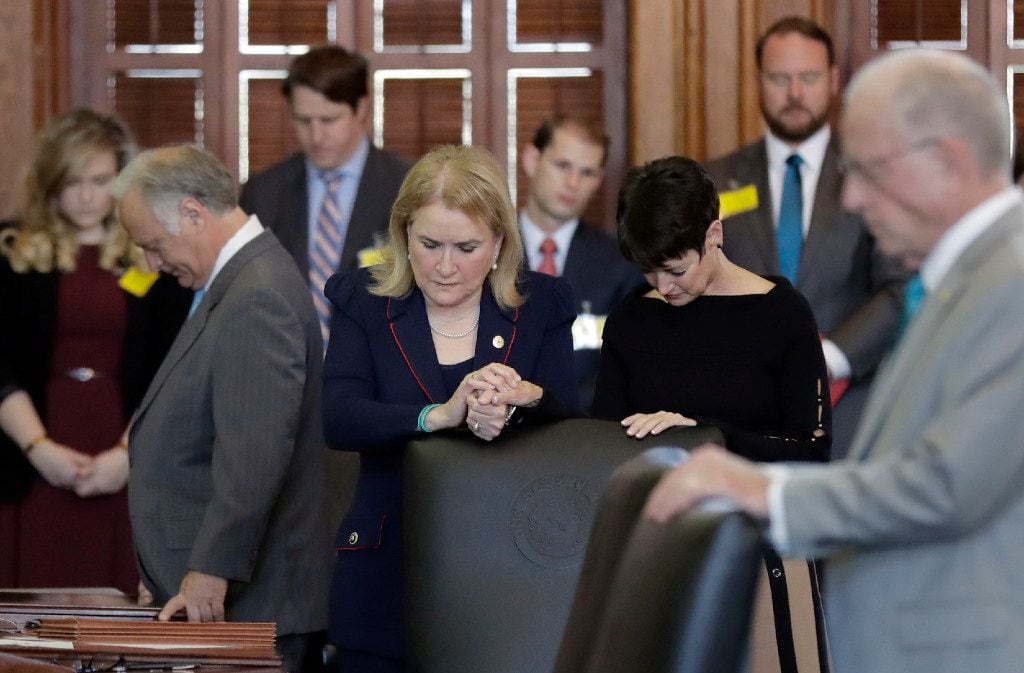 State Sen. Sylvia Garcia, D-Houston, and Sen. Donna Campbell, R-New Braunfels, joined hands...