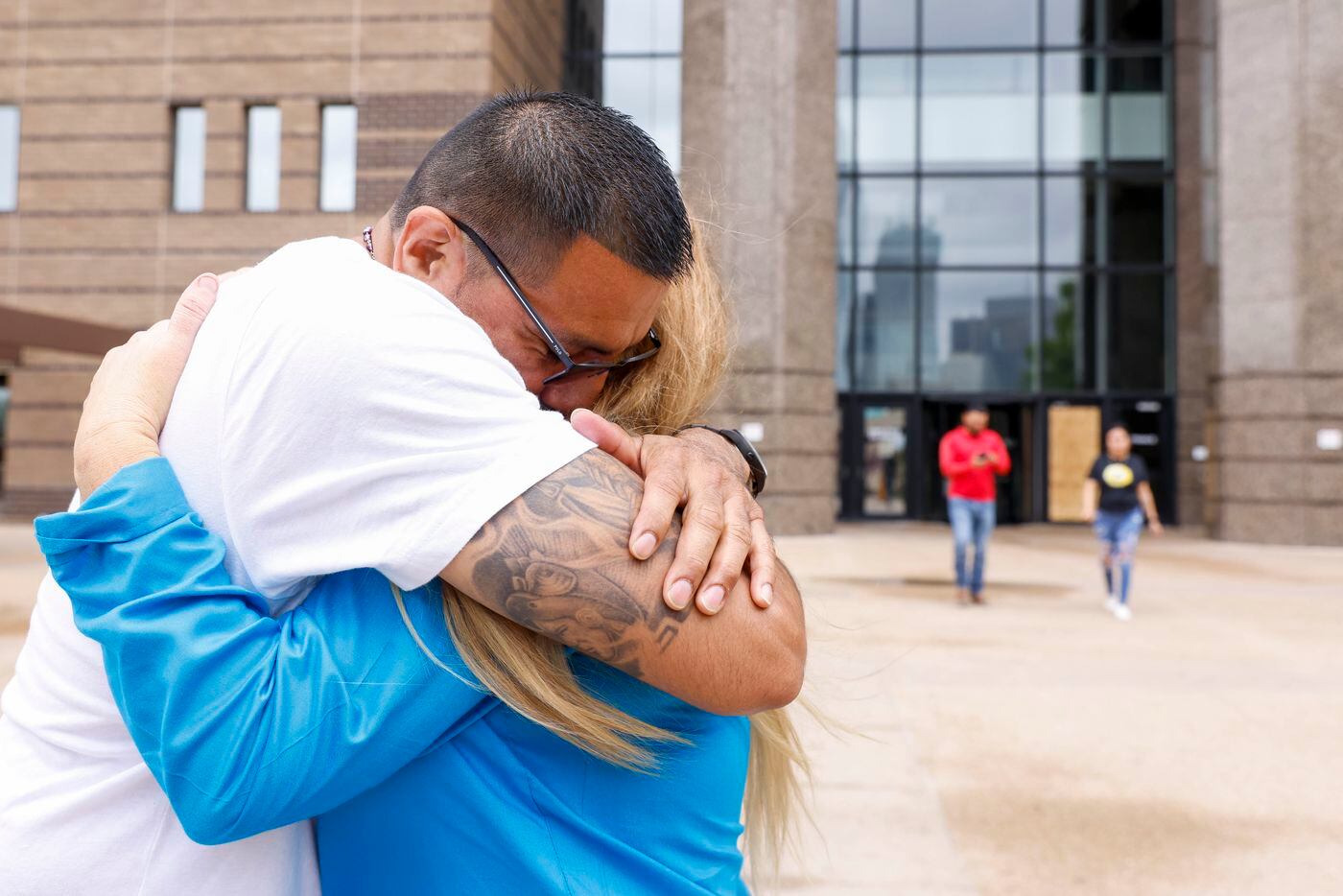 Martin Santillan hugs his long time friend Angie Bell as he leaves the courthouse after he...