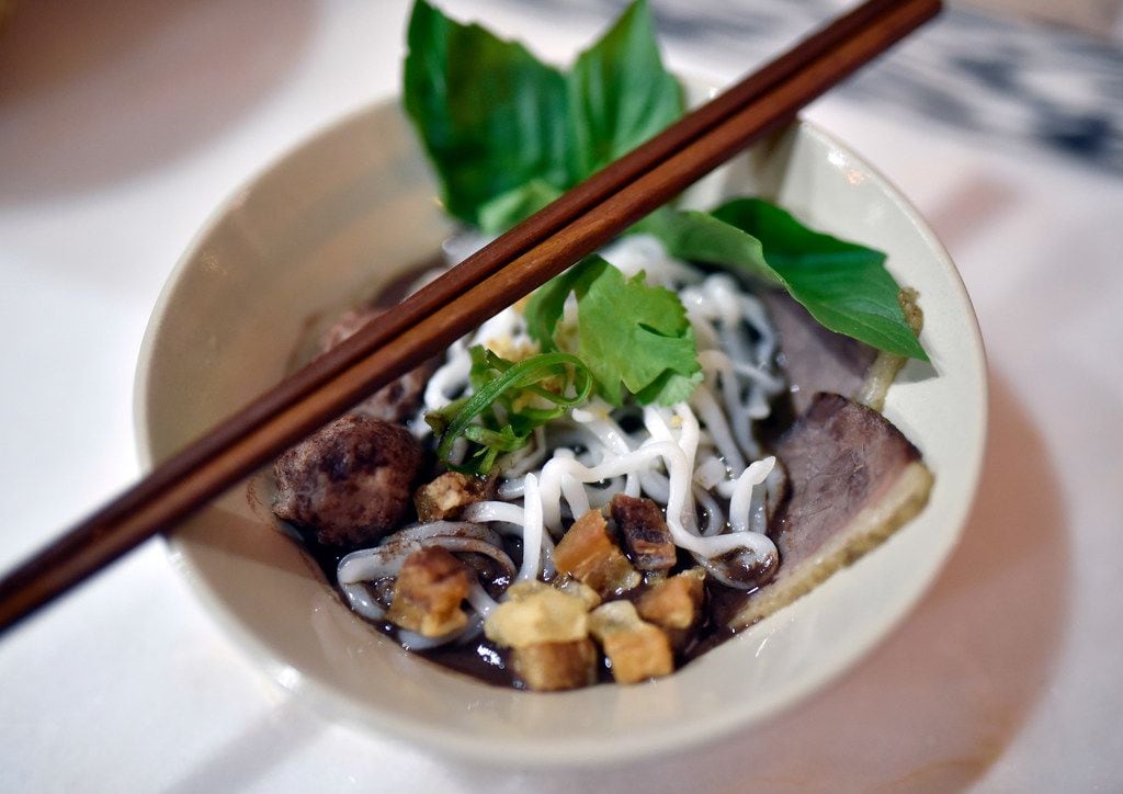A bowl of boat noodles with pork blood broth and bone marrow during a pop-up dinner...