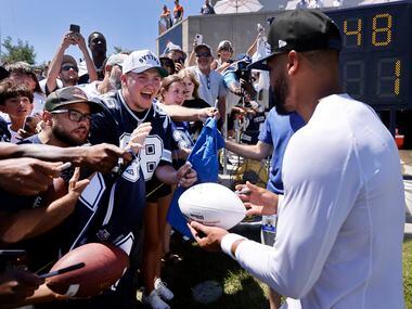 Dallas Cowboys quarterback Dak Prescott (4) signs autographs for fans following their joint...