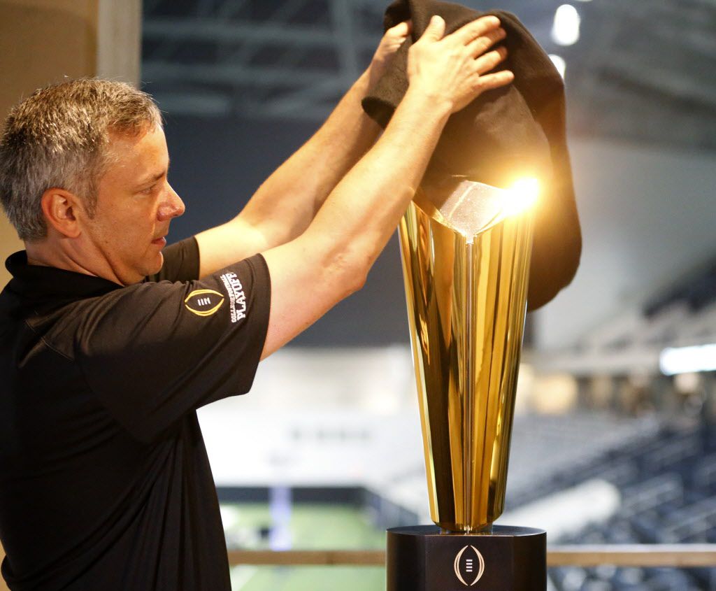 FILE - Trophy manager Charley Green sets up the national championship trophy during Big 12...