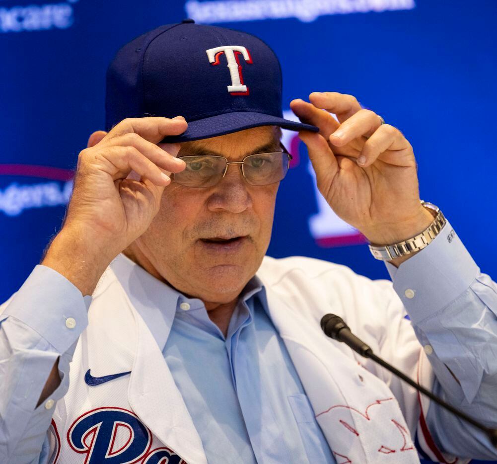 New Texas Rangers manager Bruce Bochy adjusts his hat during a press conference introducing...