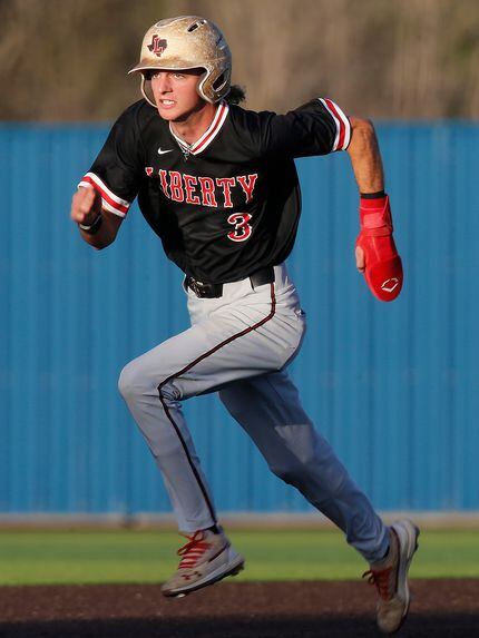Liberty shortstop Cade McGarrh heads to third base on his way to scorring the game’s first...