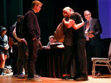 Suicide survivor, activist, storyteller and filmmaker Kevin Hines (right) comforts a student who approached him during a book signing at Ferguson Auditorium.  His keynote address was part of mental health awareness day at Texas A&M-Commerce.