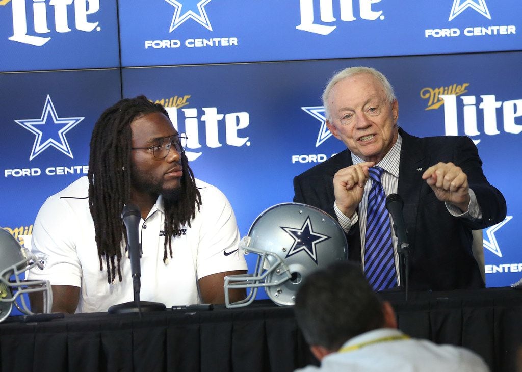 Dallas Cowboys linebacker Jaylon Smith (center) speaks alongside owner Jerry Jones (right)...