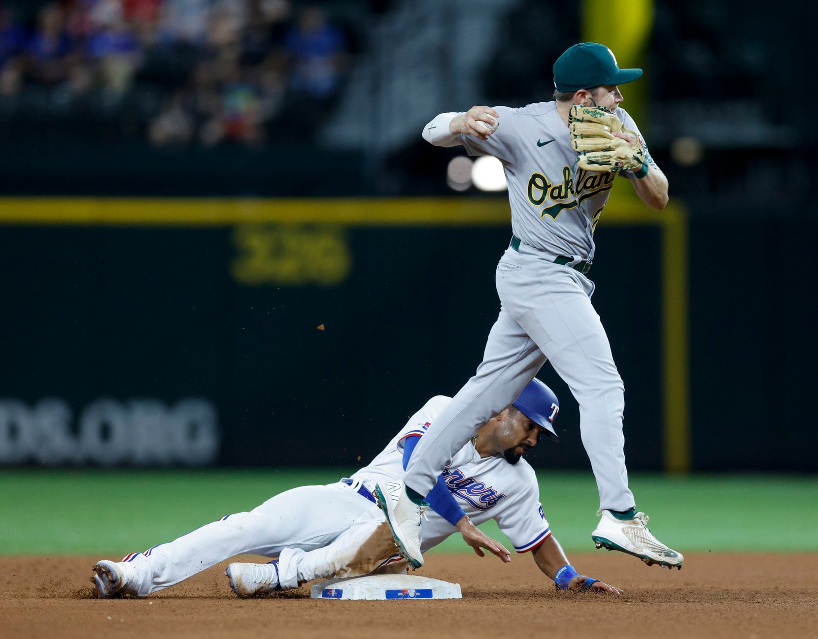 Oakland Athletics shortstop Nick Allen (2) tags second for the out on a sliding Texas...