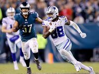 Dallas Cowboys wide receiver CeeDee Lamb (88) runs in open space after catching a fourth...