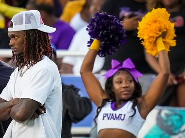 Dallas Cowboys wide receiver CeeDee Lamb (left) watches from the Prairie View sidelines...