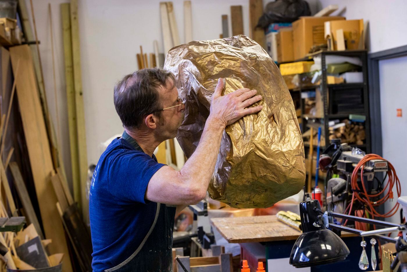 Prop designer Tommy Bourgeois adds shimmer to a gold nugget prop for Dallas Opera’s Das...