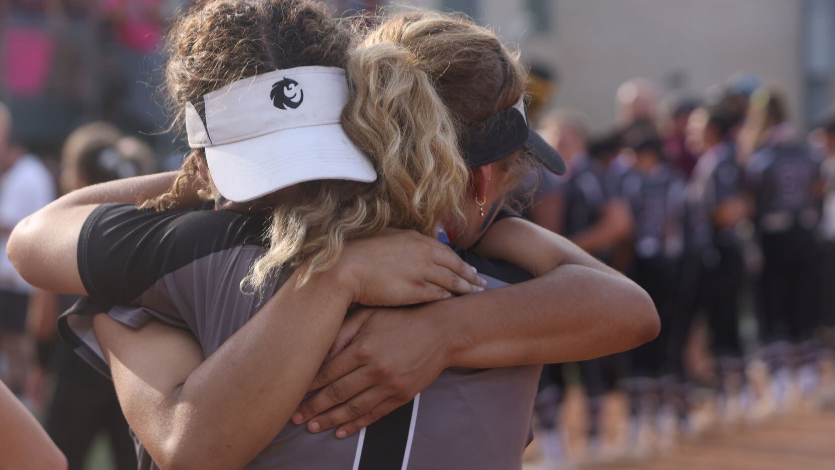Avery Jefferson (1) and teammate Tehya Pitts (7) share a consoling hug following the team's...