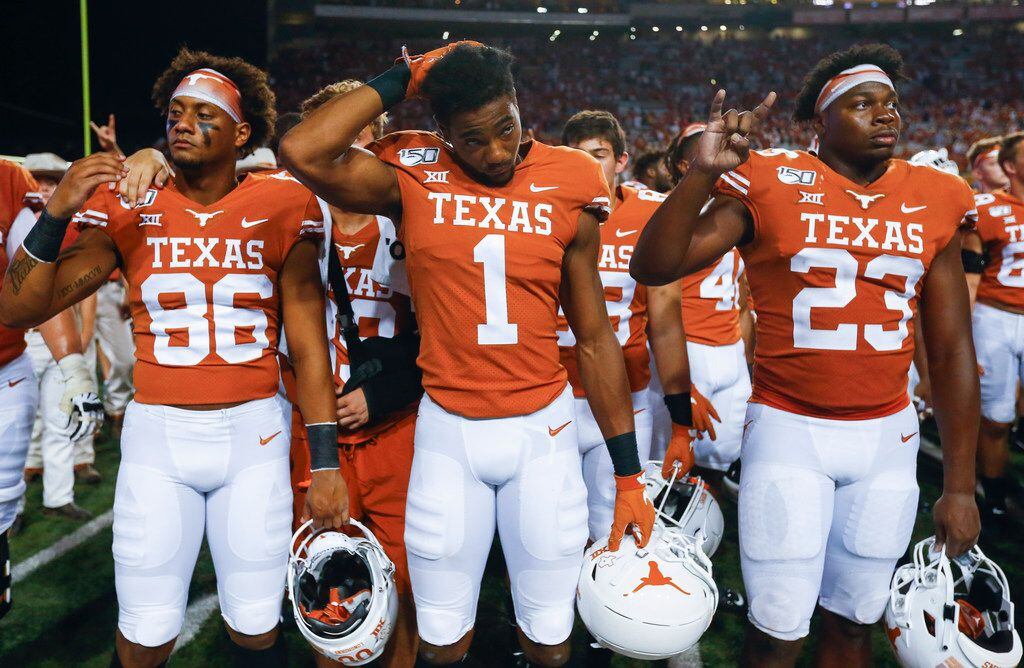 Texas Longhorns wide receiver Jordan Pouncey (86), wide receiver John Burt (1) and linebacker Jeffrey McCulloch (23) participate in The Eyes of Texas following their loss to LSU on Saturday, Sept. 7, 2019 at Darrell Royal Memorial Stadium in Austin, Texas.