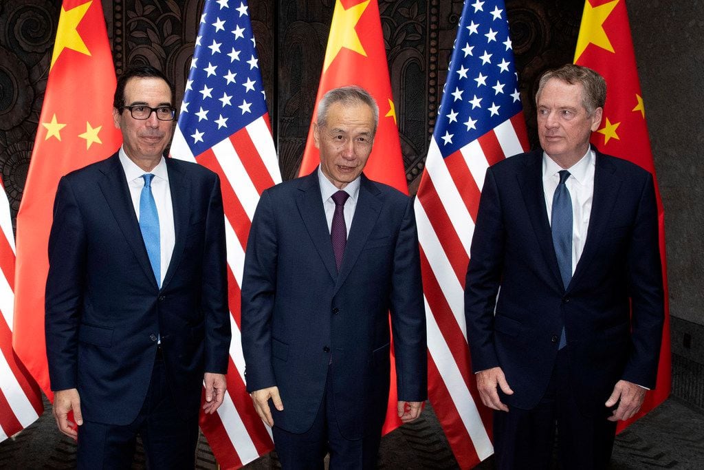 Chinese Vice Premier Liu He, center, poses with U.S. Trade Representative Robert Lighthizer,...