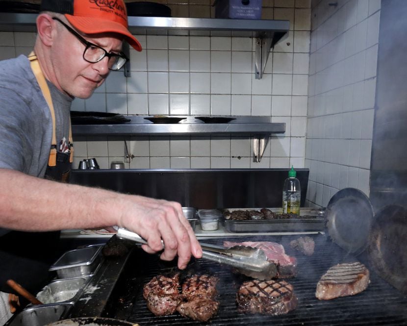 Brian Luscher, the second owner and chef, works the grill.