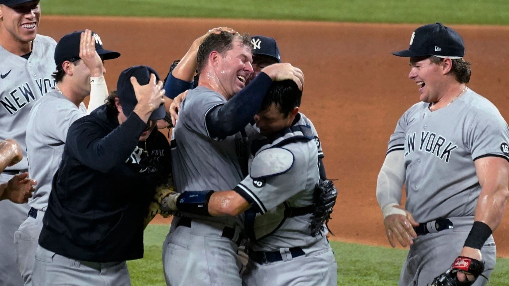 New York Yankees starting pitcher Corey Kluber, third from right, celebrates with catcher...