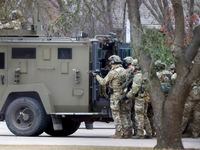 A law-enforcement team stages behind an armored vehicle outside Congregation Beth Israel in Colleyville on Saturday, Jan. 15, 2022.