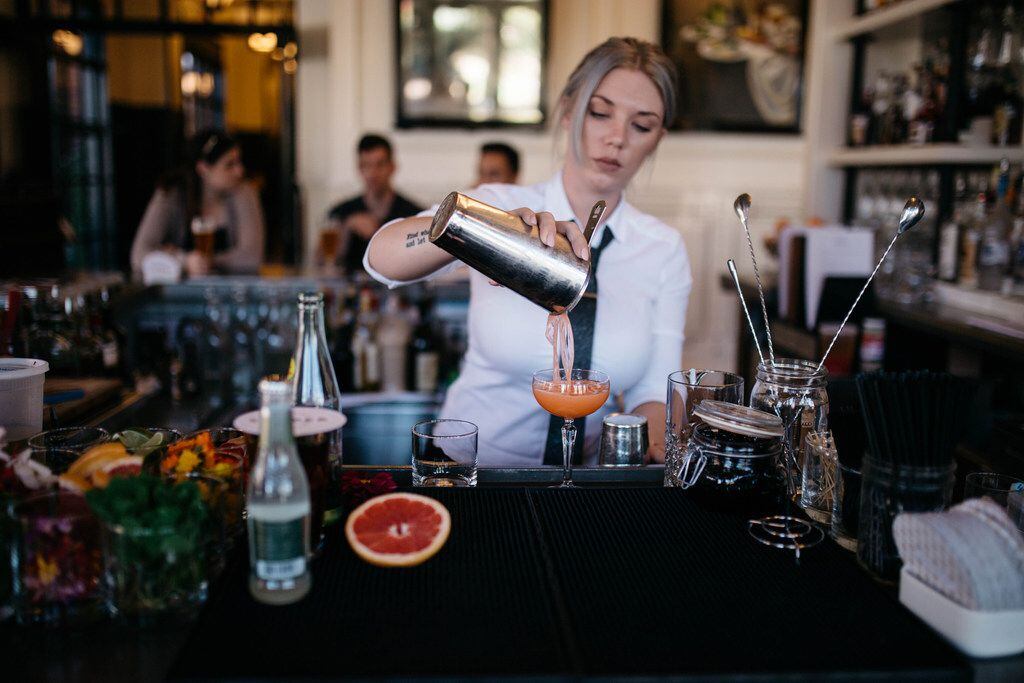 A bartender pours a drink at the Hotel Emma in San Antonio. 