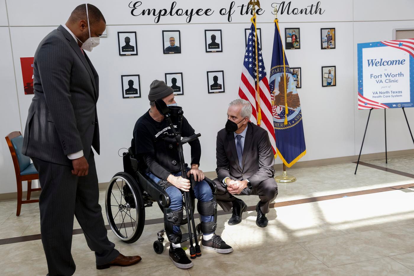 Veterans Secretary Denis McDonough (right) speaks with Army veteran John Caruso (center)...
