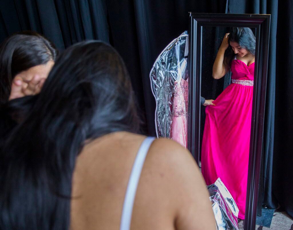 H. Grady Spruce High School student Edith Delgado, 17, tries on a prom dress during TLC's...
