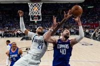 Dallas Mavericks center Daniel Gafford (21) and LA Clippers center Ivica Zubac (40) reach...
