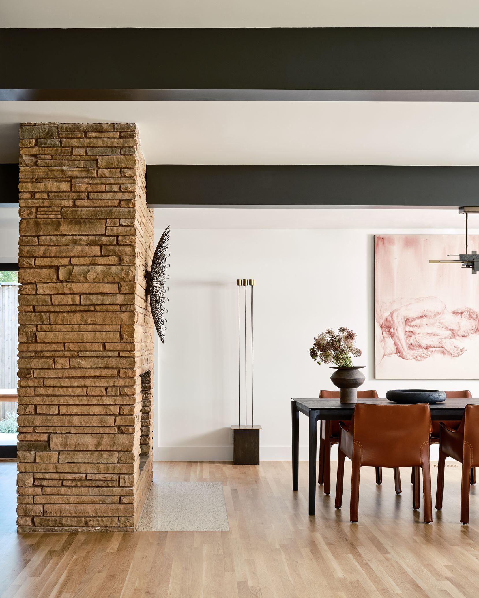 An original brick fireplace separates the dining room from the kitchen.