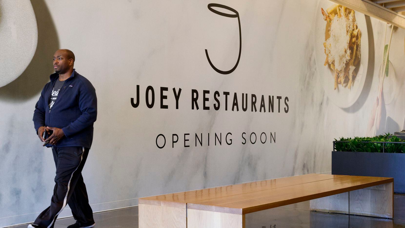 A barricade inside NorthPark Center announces that a restaurant named Joey is "opening soon"...