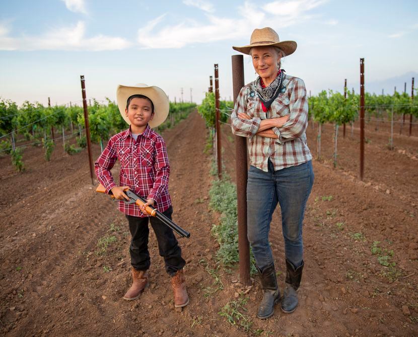 Andis Applewhite and nephew Calvin Wallace Gloria, 8, stood in Applewhite's vineyard in...
