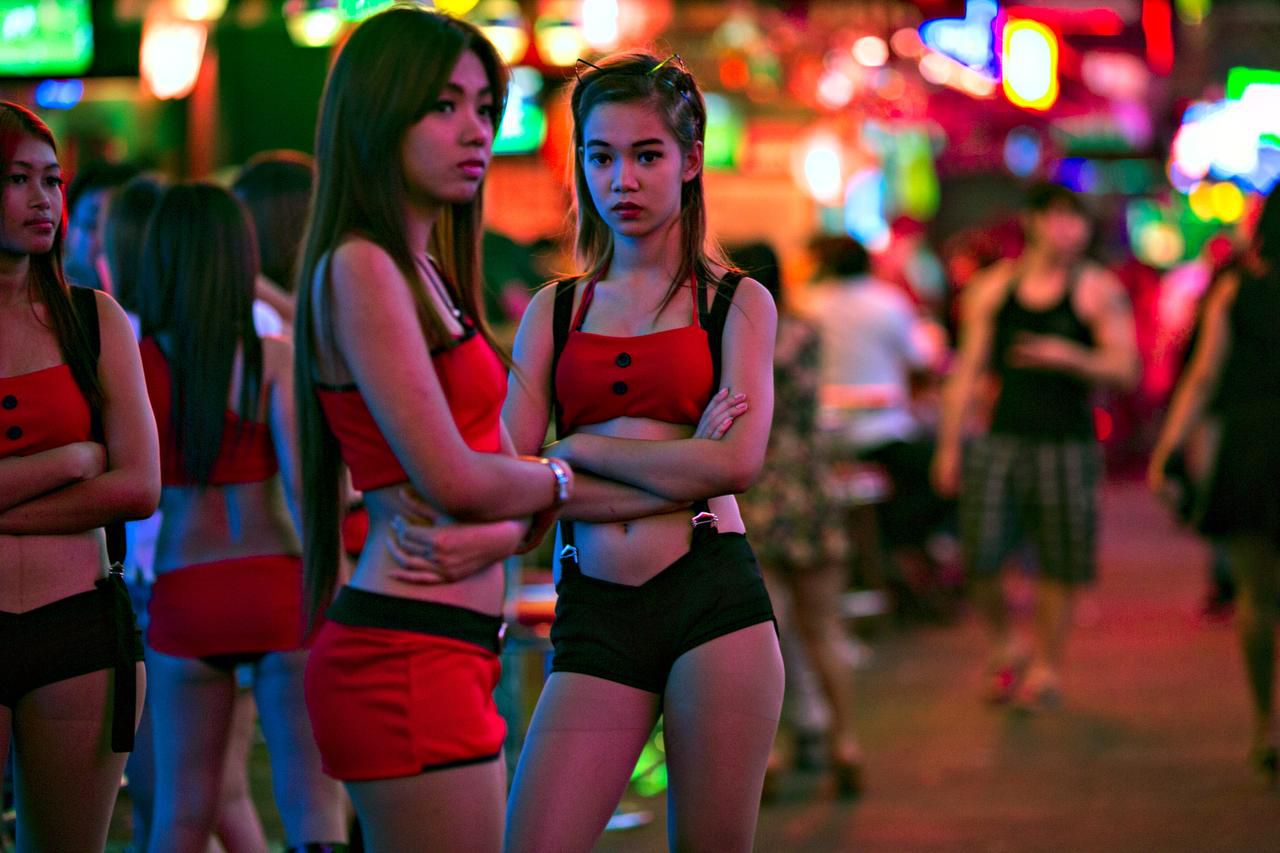 Women working at a bar in Bangkok wait for business in the red light distri...