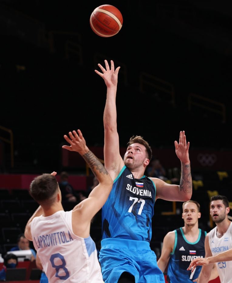Slovenia’s Luka Doncic (77) attempts a shot in front of Argentina’s Nicolas Laprovittola (8) in the first half of play during the postponed 2020 Tokyo Olympics at Saitama Super Arena on Monday, July 26, 2021, in Saitama, Japan. Slovenia defeated Argentina 118-100. (Vernon Bryant/The Dallas Morning News)