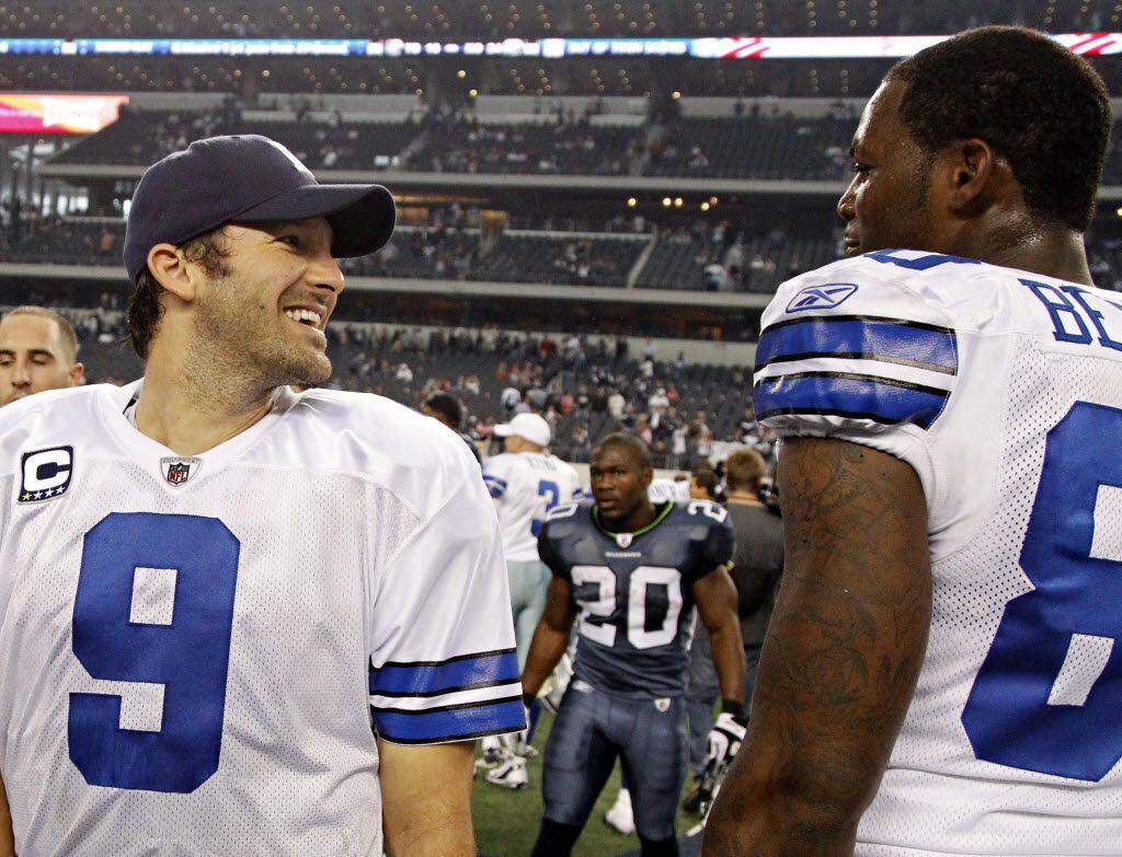 Dallas Cowboys quarterback Tony Romo (9) smiles at tight end Martellus Bennett as they walk...