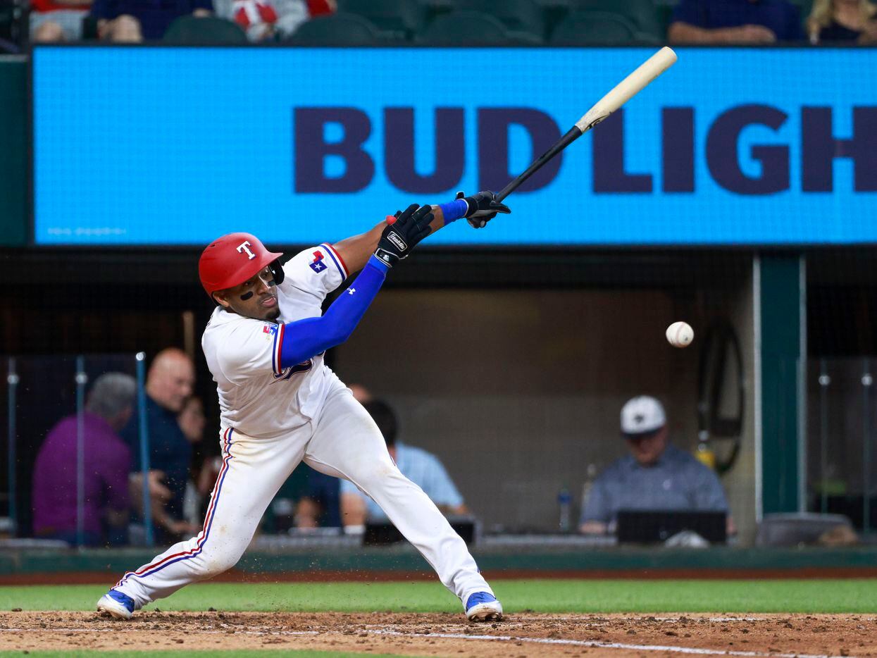 Texas Rangers third baseman Andy Ibanez (77) hits a ball during the sixth inning against the...