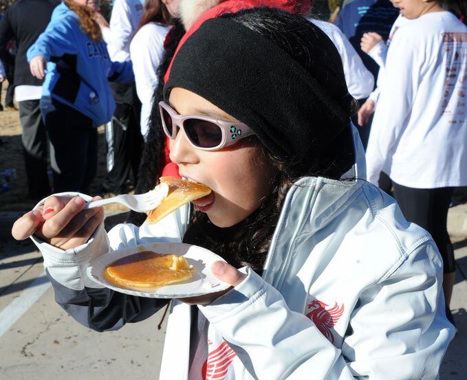 Sofie Ponce eats a pancake after running in the Hotcake Hustle.