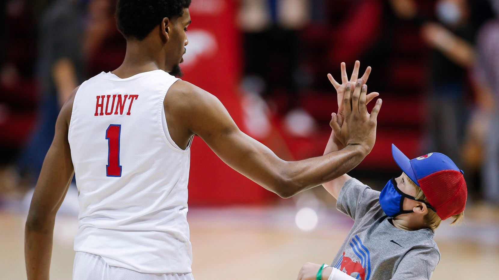 SMU forward Feron Hunt (1) high-fives a fan after a college basketball game against Memphis...