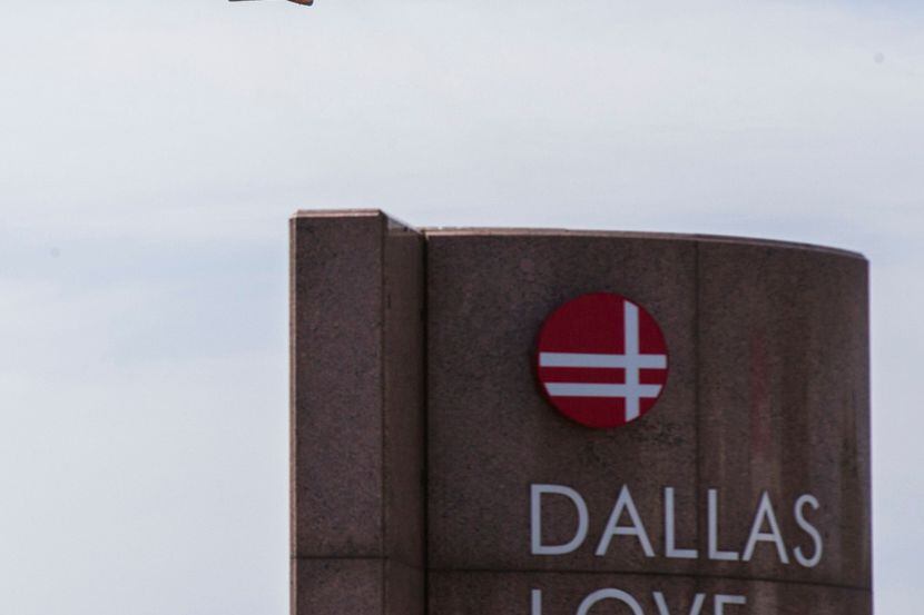 A Southwest Airlines plane flies over Love Field Airport in Dallas. 