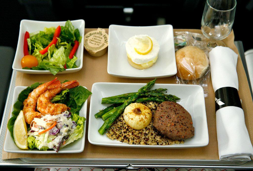 Shrimp Remoulade, seasonal greens, peppercorn crusted beef tenderloin, and lemon coconut layer cake served in the new premium economy cabin seating on the American Airlines new 787-9 Dreamliner at DFW Airport on Nov. 3, 2016.  (Nathan Hunsinger/The Dallas Morning News)   American Airlines new 787-9 Dreamliner at DFW Airport on Nov. 3, 2016.  (Nathan Hunsinger/The Dallas Morning News)